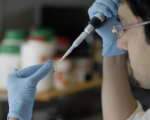 Researcher pipetting small amounts of sample (from the Brain Repair Centre)